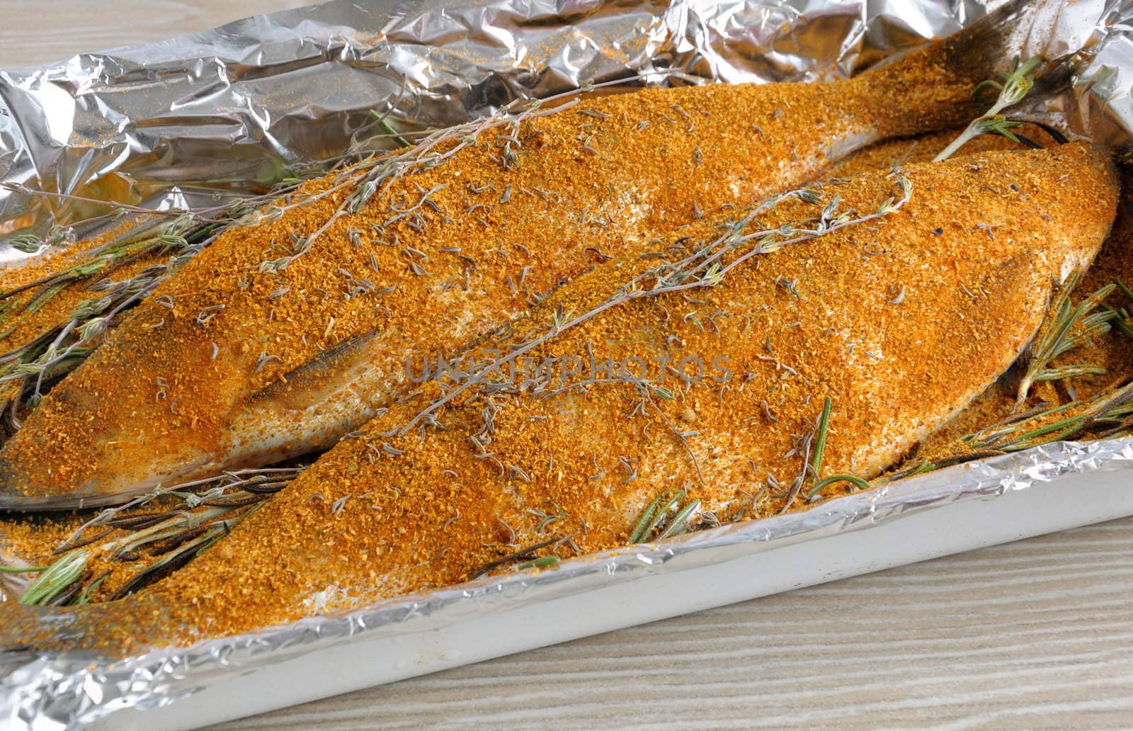 Fresh herring in spices and herbs in foil