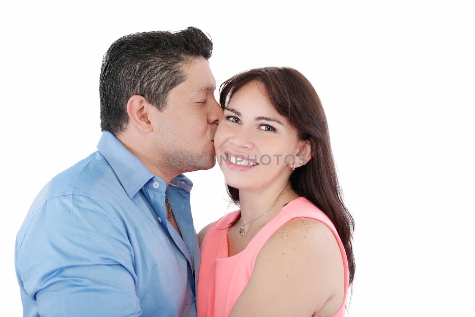 Close-up portrait of woman being affectionately kissed by her hu by dacasdo