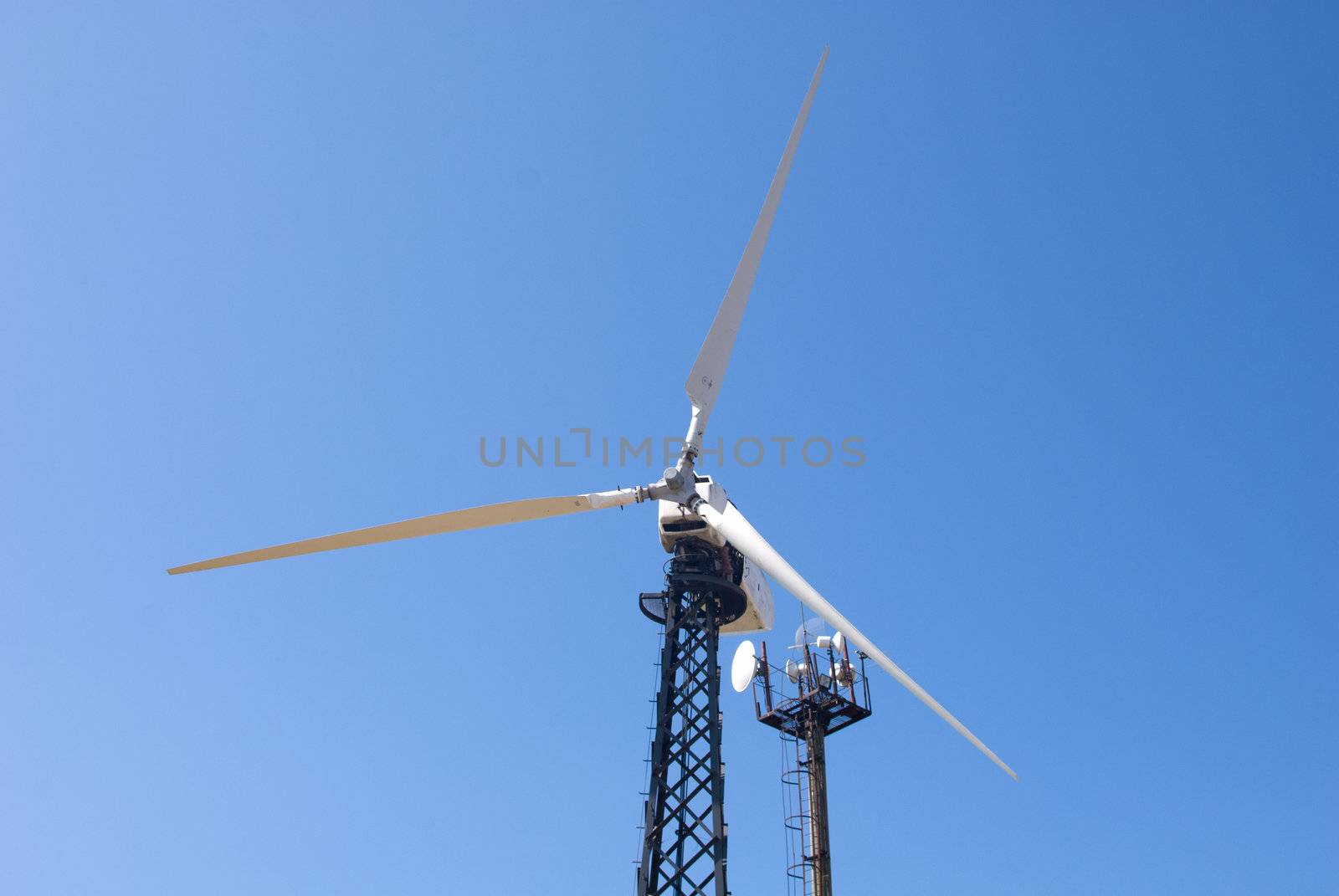 wind energy, modern white wind turbine or wind mill producing energy to power a city