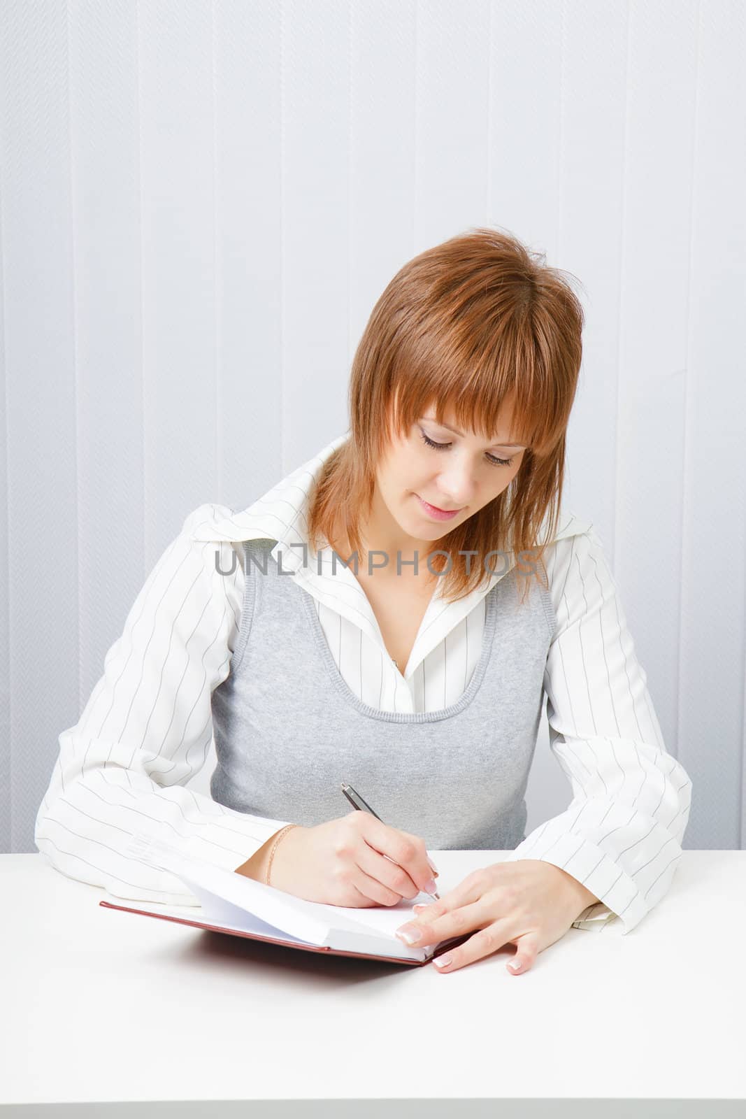 Attractive girl with a notepad and pen