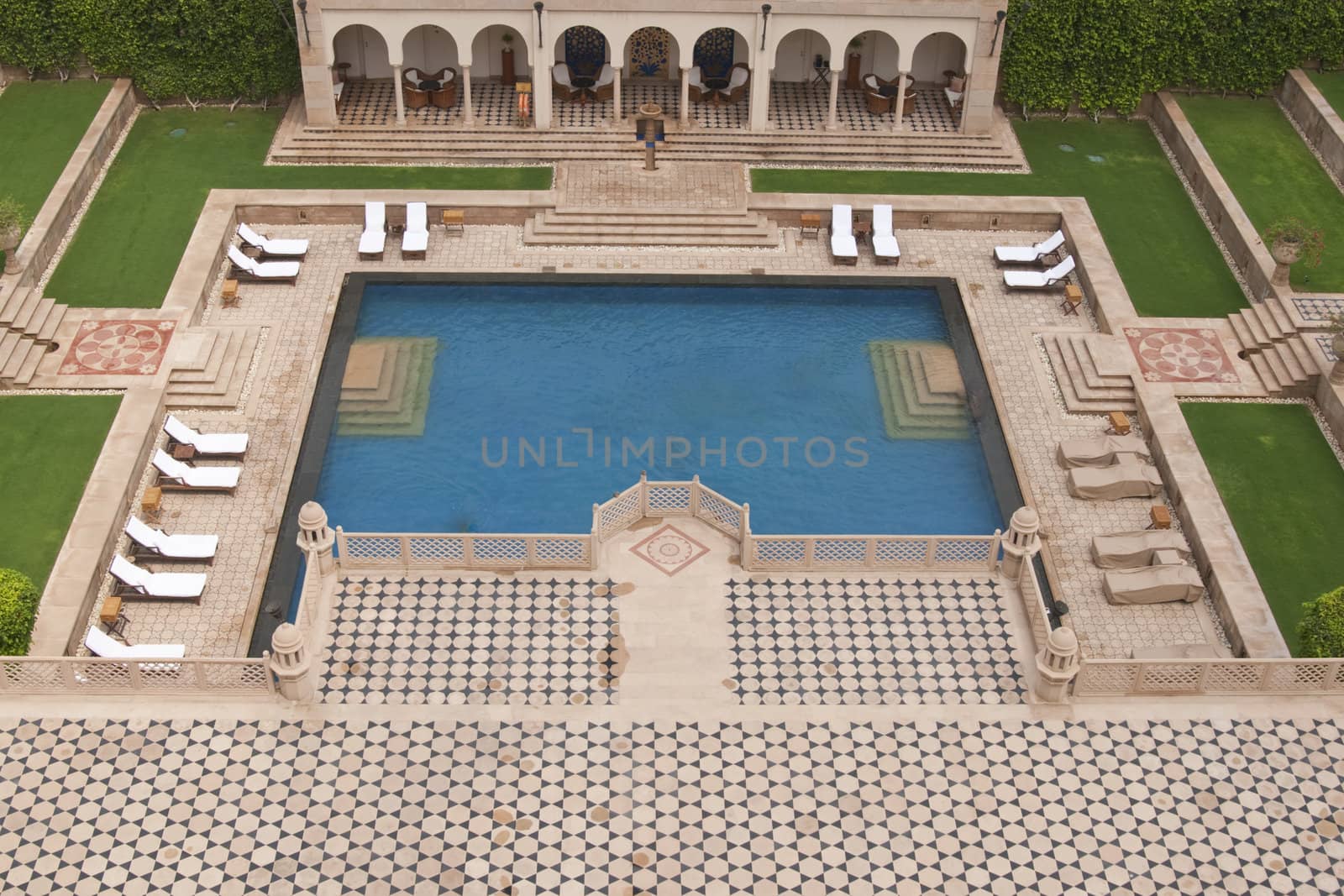 Swimming pool set in in Mughal style landscaped gardens. Luxury Hotel, Agra, India