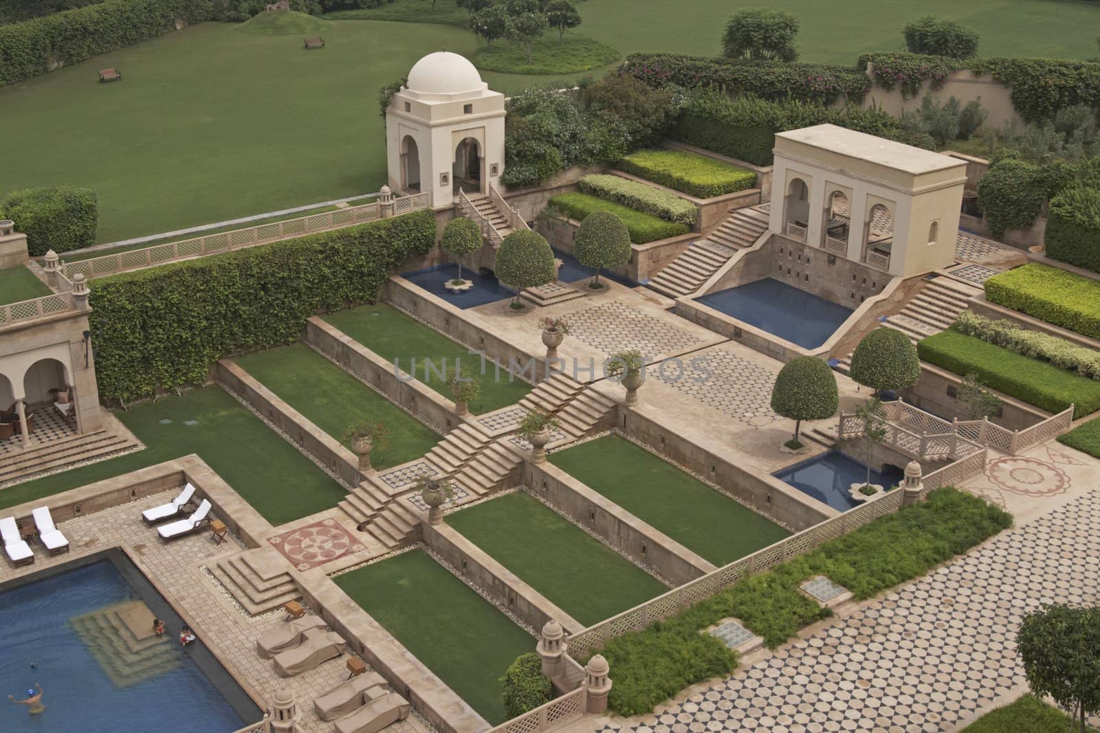 Terraced gardens and swimming pool in a Mughal style walled garden. Luxury Hotel, Agra, India