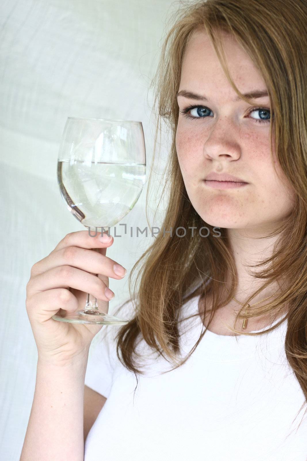 Girl with a glass of water looking at the camera