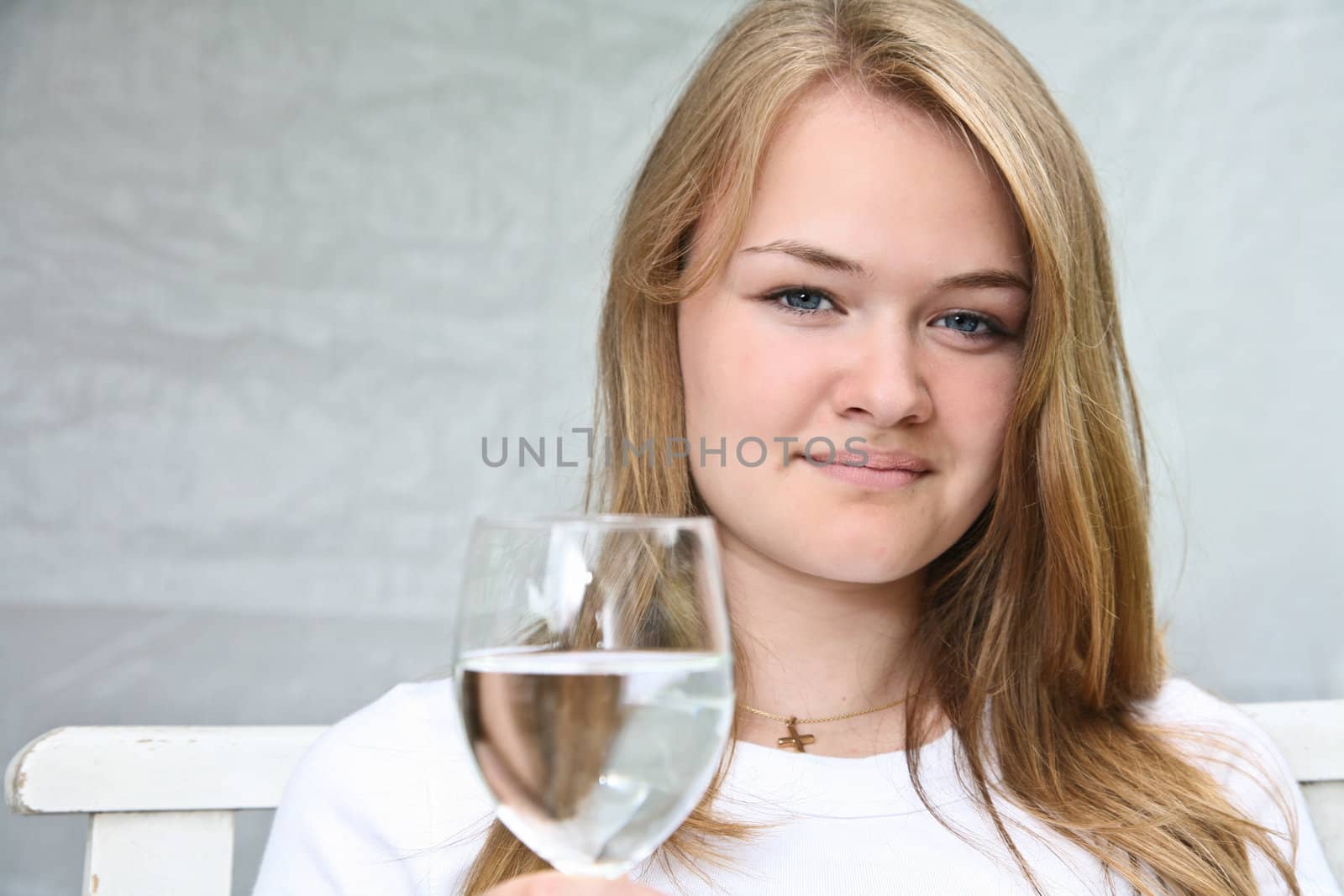 Girl with a glass of water looking at the camera