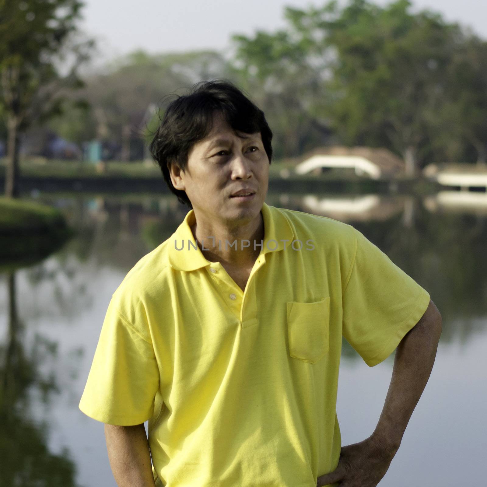 A portrait of a senior south asian man by lake