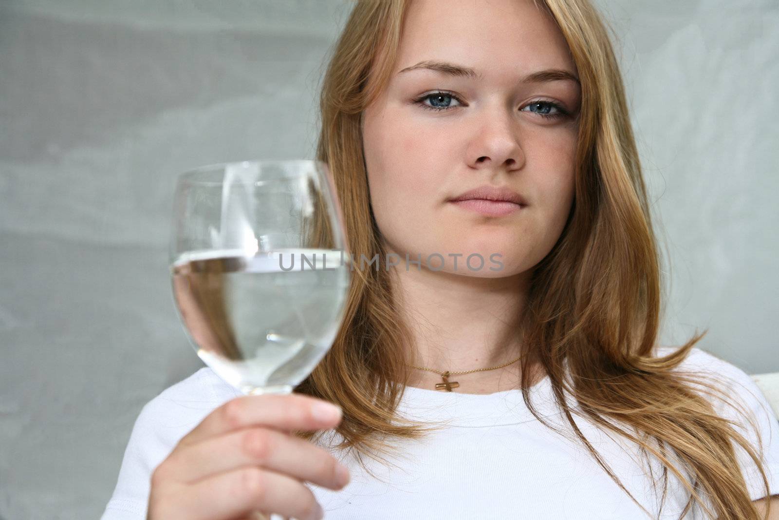 Girl with a glass of water looking at the camera