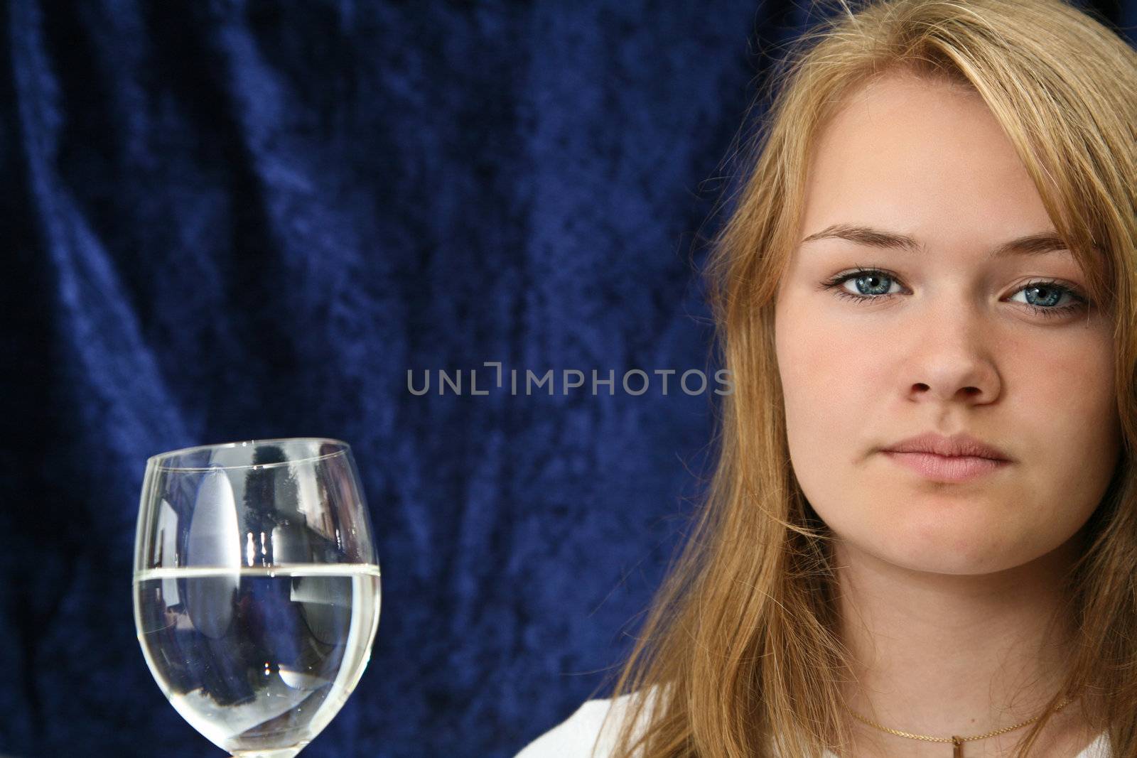 Girl with a glass of water looking at the camera