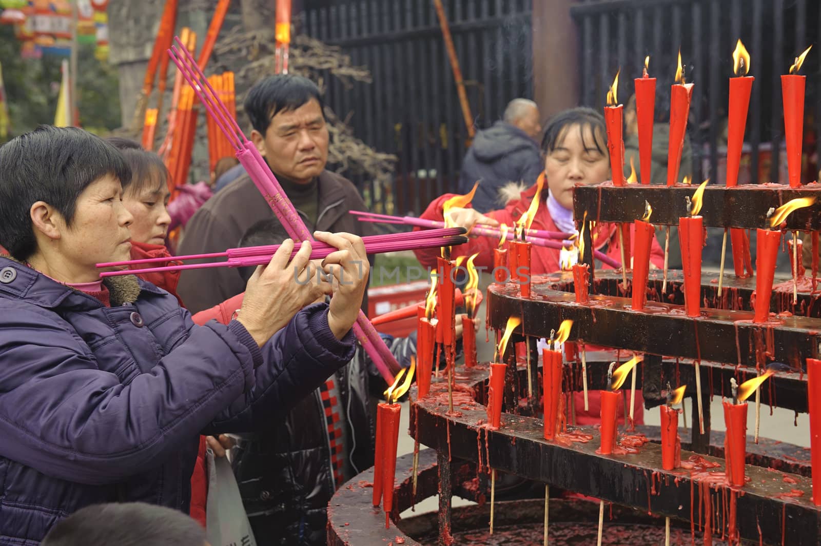 CHENGDU - FEB 5: People burning incense upon the incense altar in temple during chinese new year on Feb 5, 2011 in Chengdu, China.Many people want to relieve their worries and difficulties by burning incense and praying to Buddha during festivals.It's part of the important traditional custom in China.