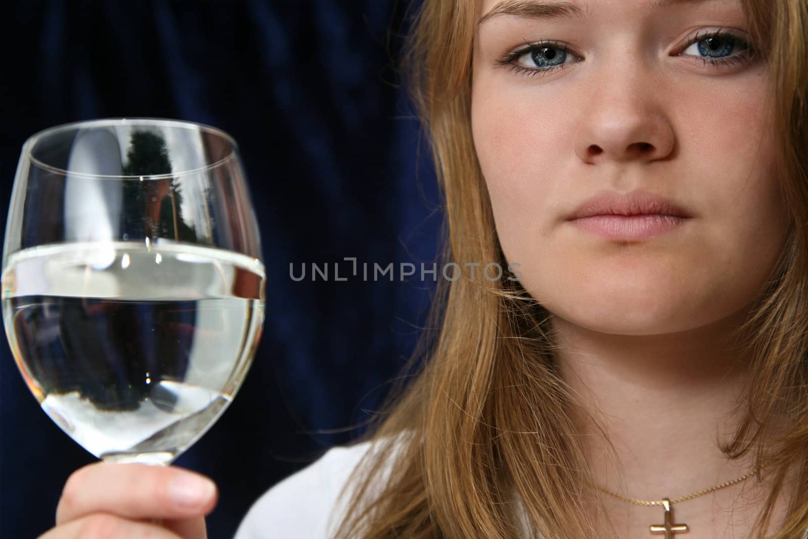 Girl with a glass of water looking at the camera