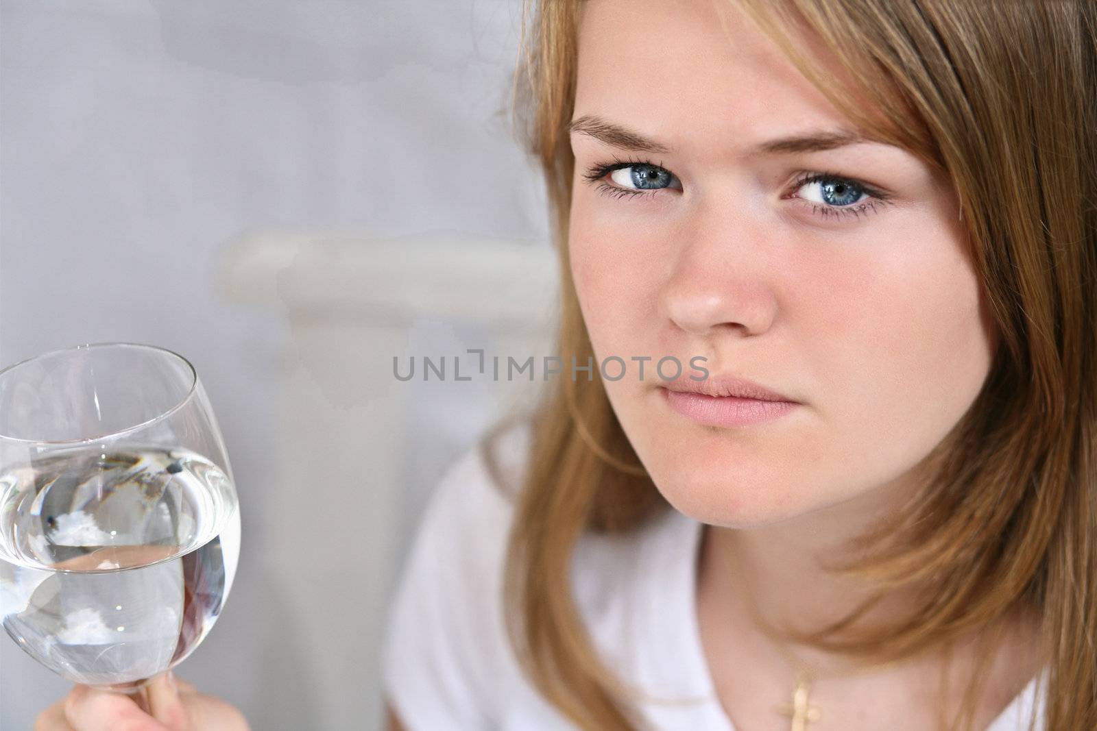 Girl with a glass of water looking at the camera