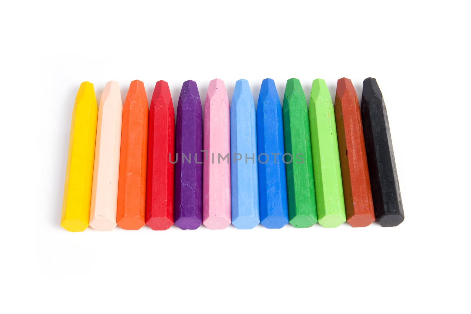 Colored wax crayons isolated on white background