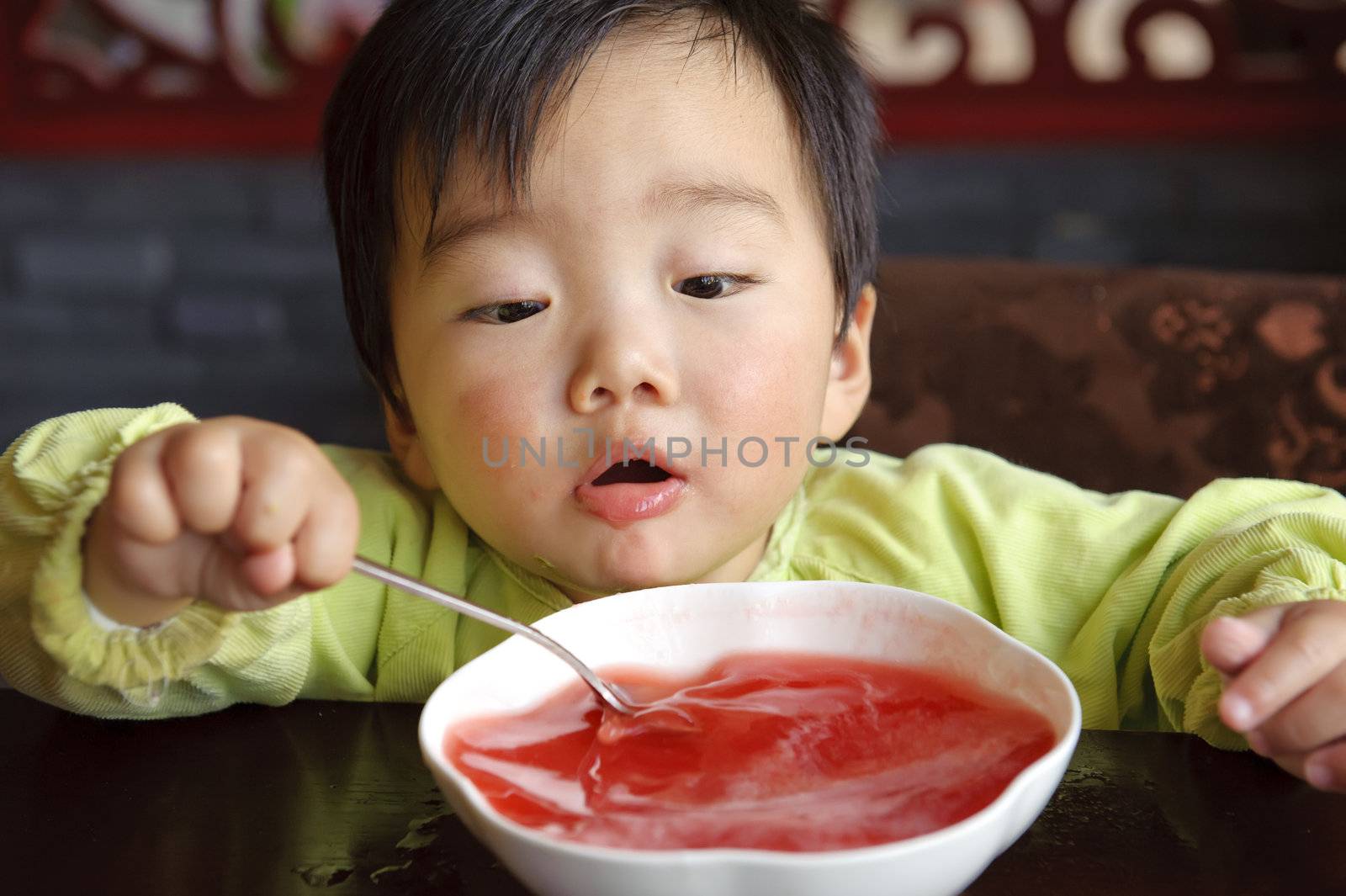 a cute baby to drink soup