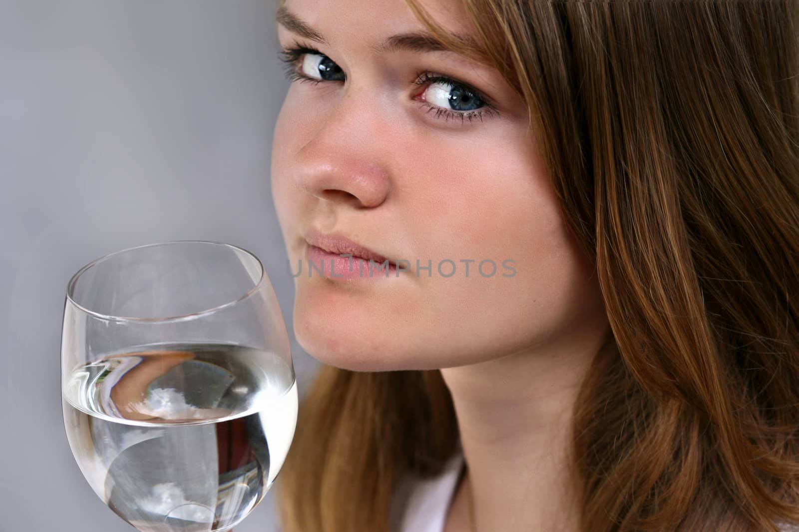 Girl with a glass of water looking at the camera