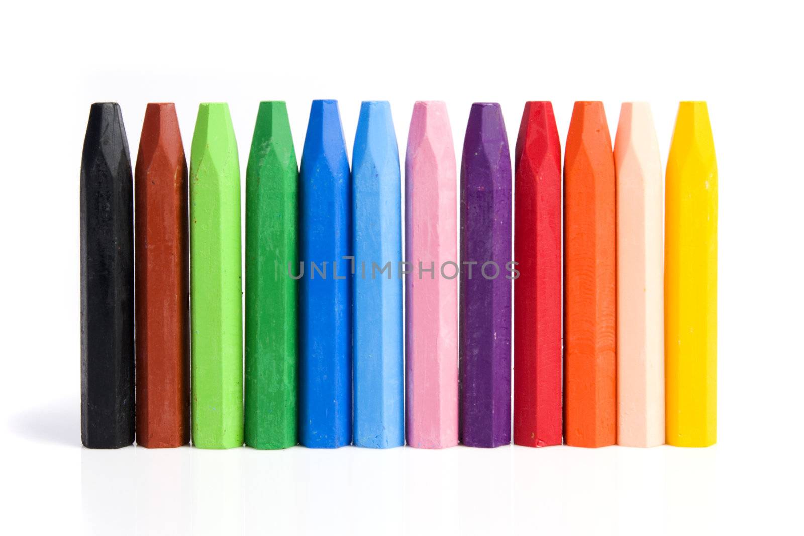 Colored wax crayons isolated on white background