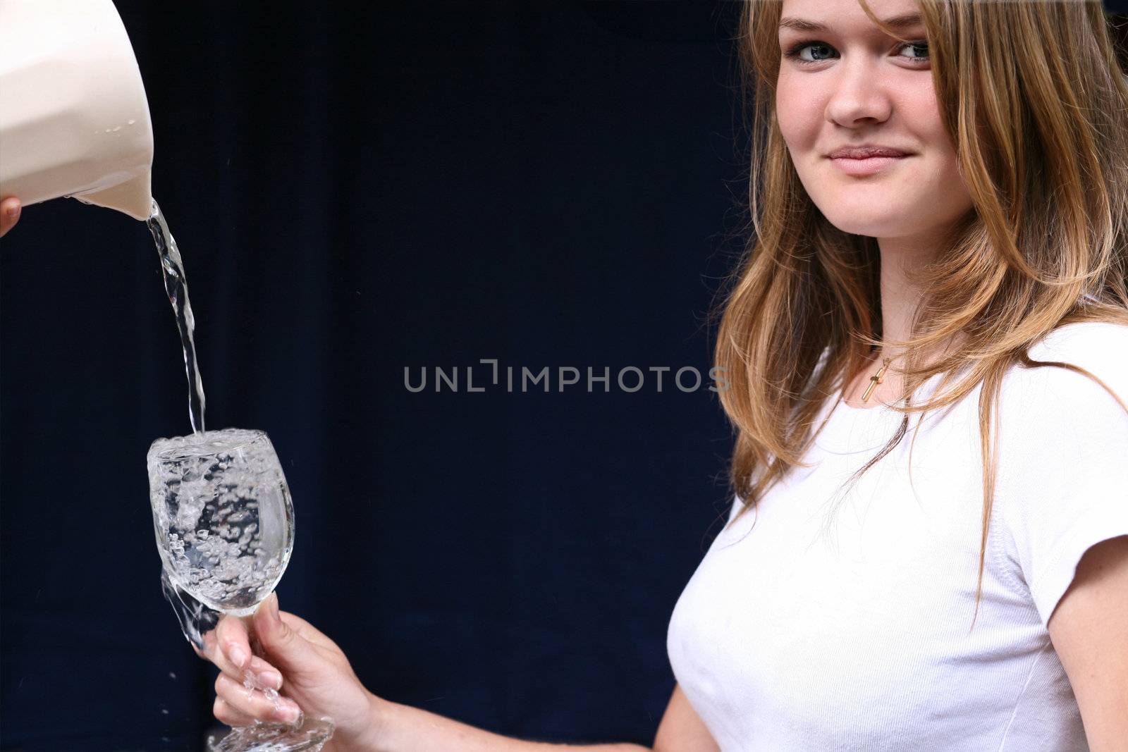 Girl with a glass of water looking at the camera