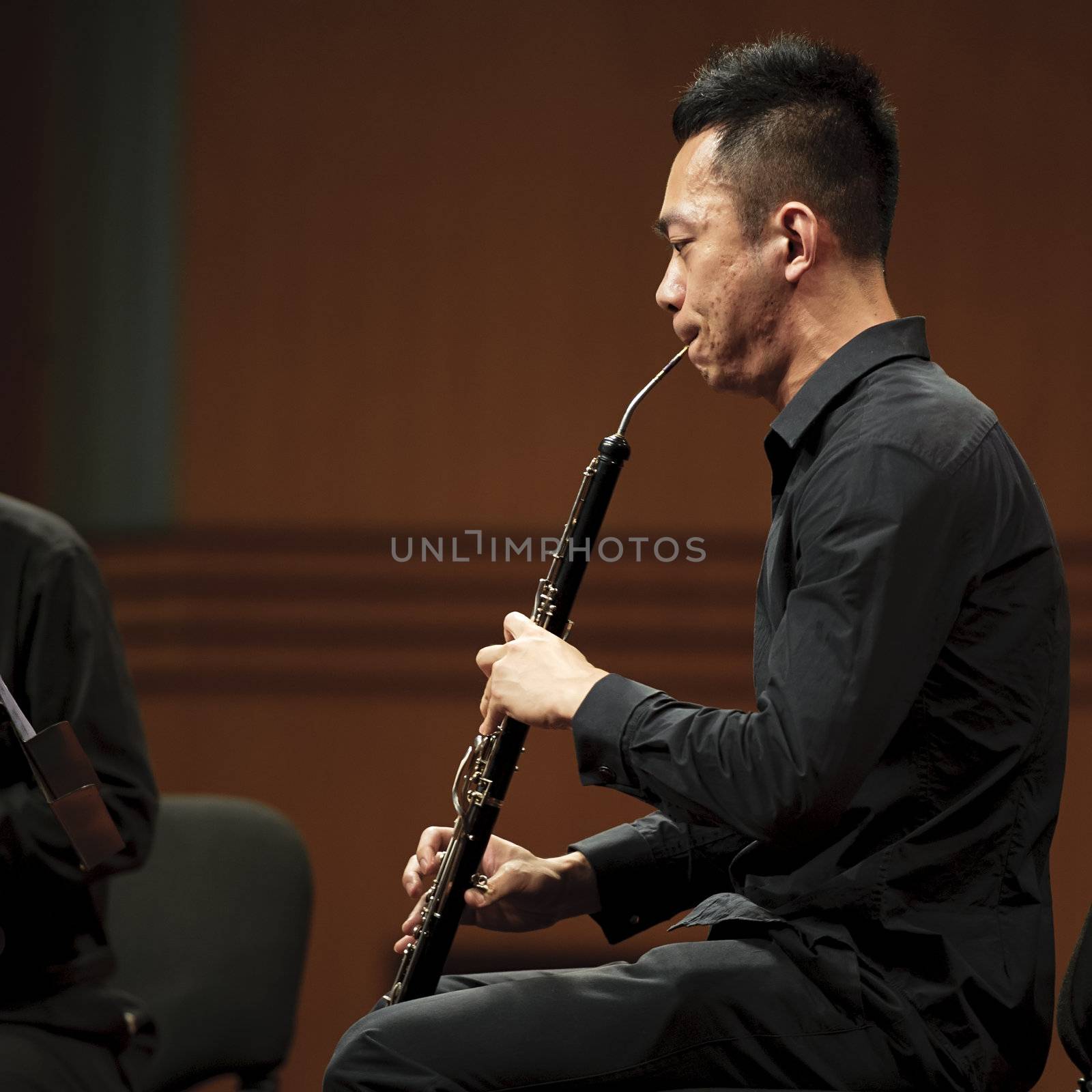 CHENGDU - JUN 20: musician performs English horn on wind music chamber music concert at odeum of Sichuan Conservatory of Music on Jun 20,2012 in Chengdu,China.