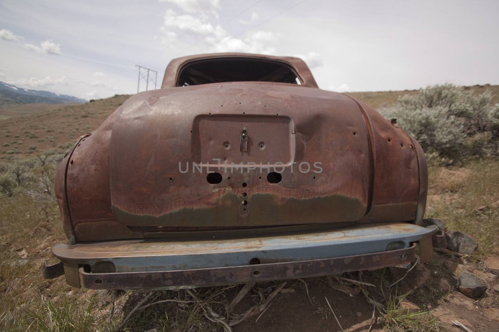 Old abandoned car with bullet holes by jeremywhat