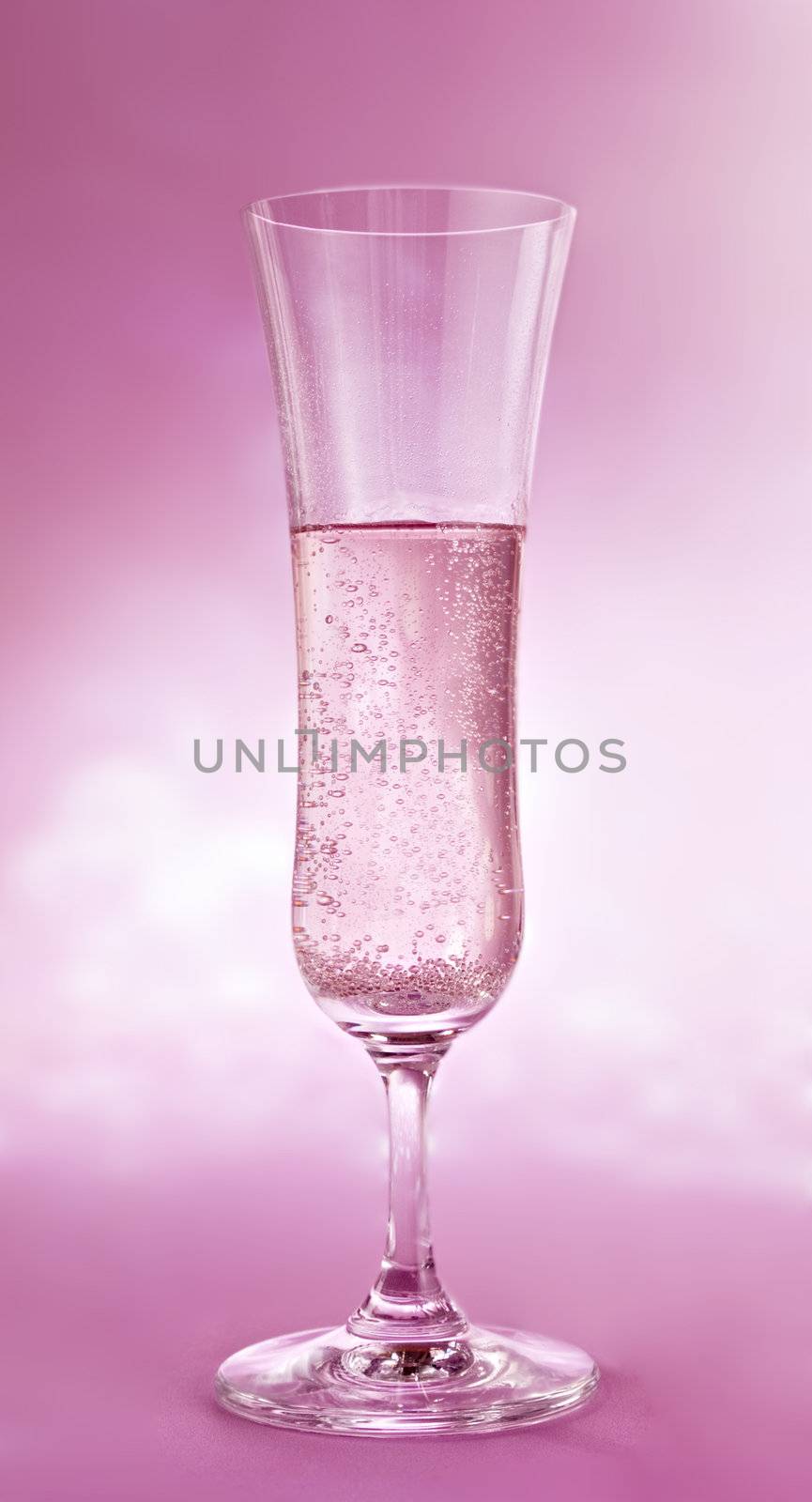 a glass  of champagne on pink background by ozaiachin