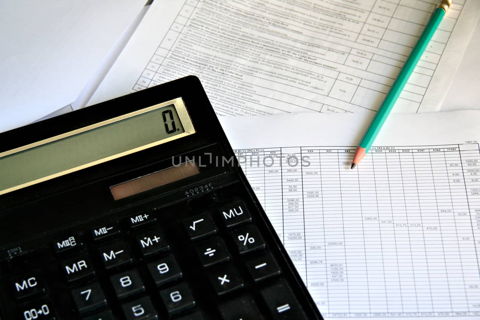 Calculator and pencil on white background close up