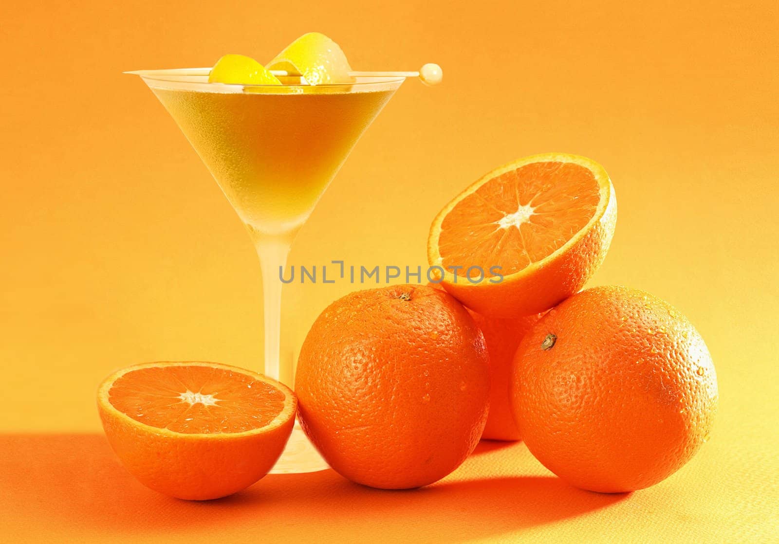 Fresh fruit and juice on orange background