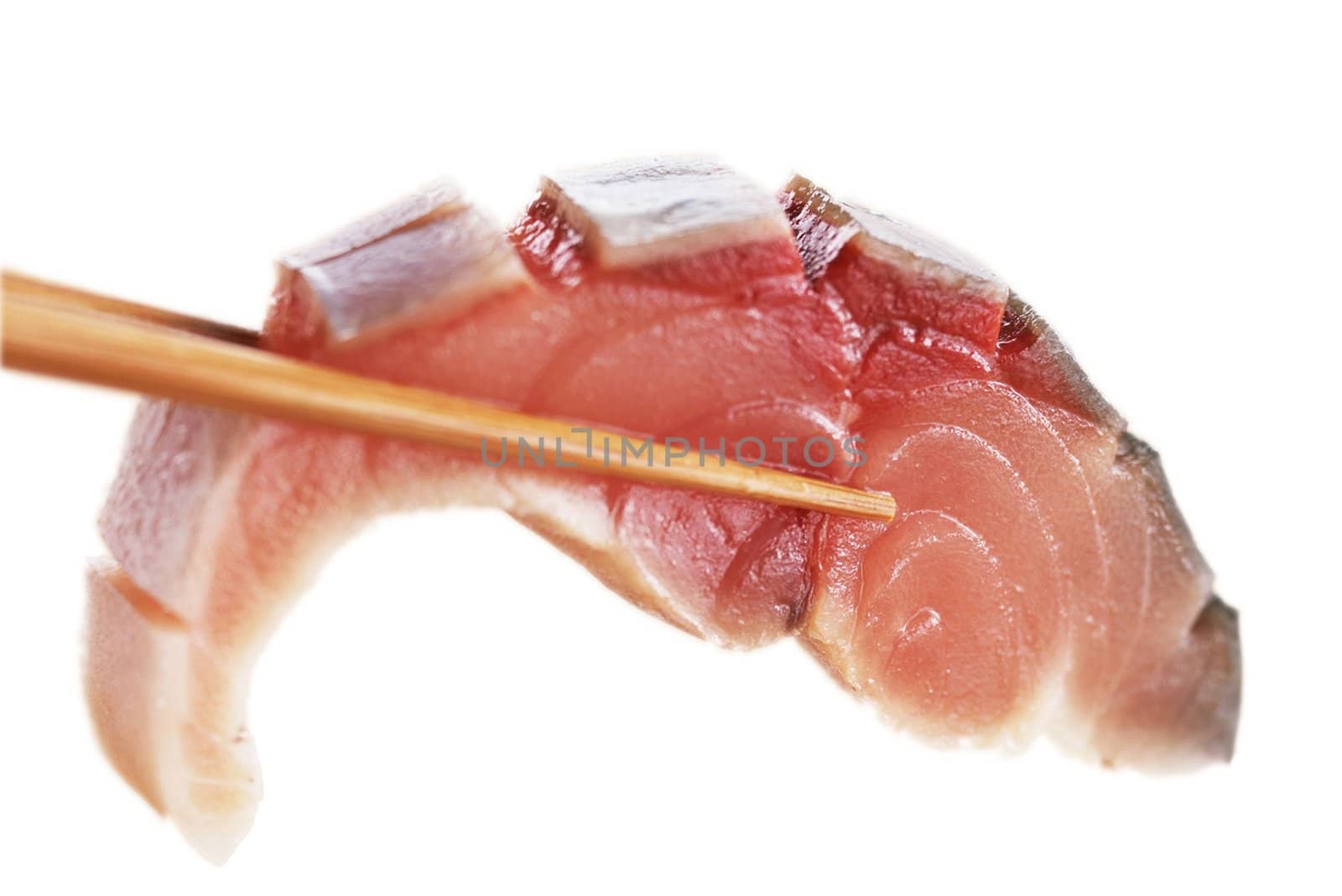 A piece of fish meat in chopsticks on white background
