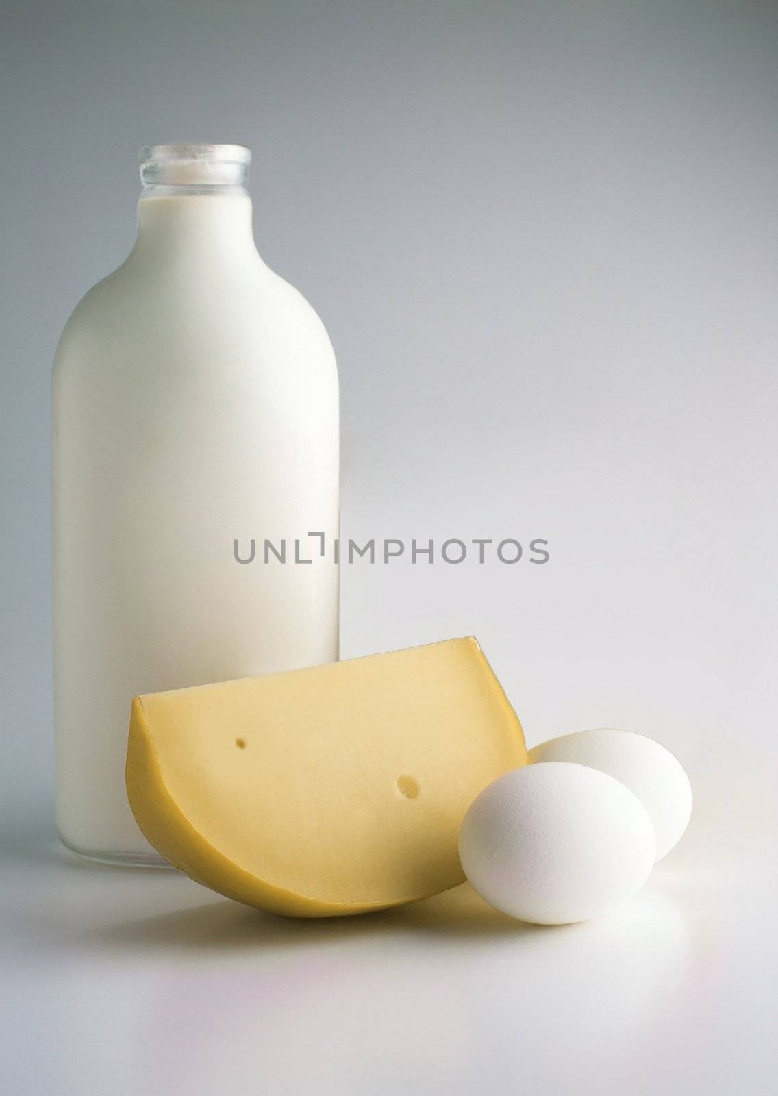 Milk products and eggs. Milk bottle, eggs and cheese.