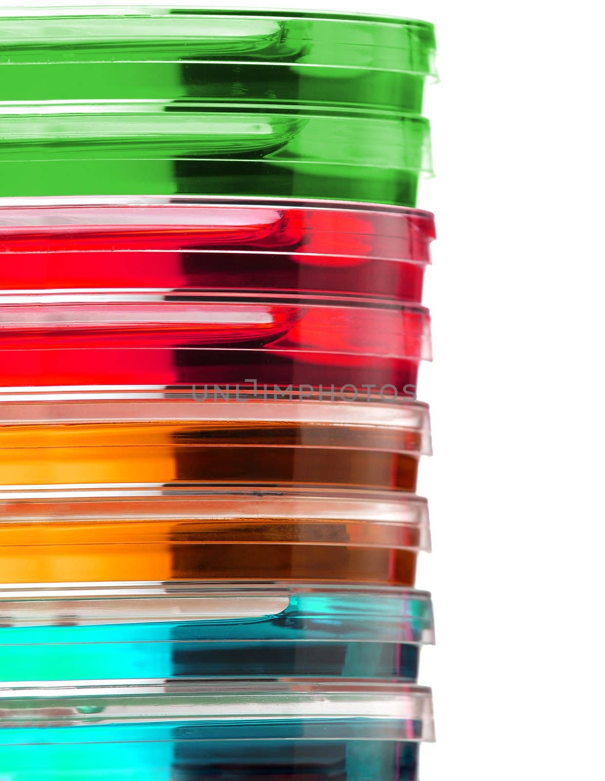 Stack of colorful Petri dishes isolated over white background