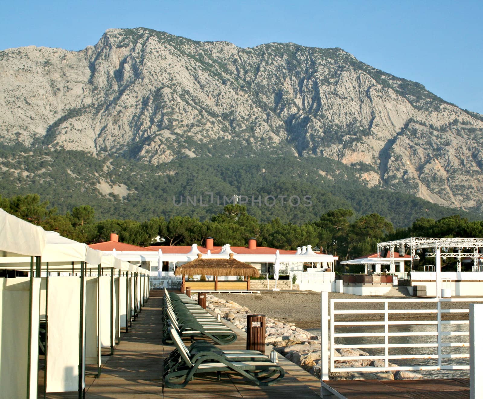 Sky, ocean, mountain, beach, and buildings close up