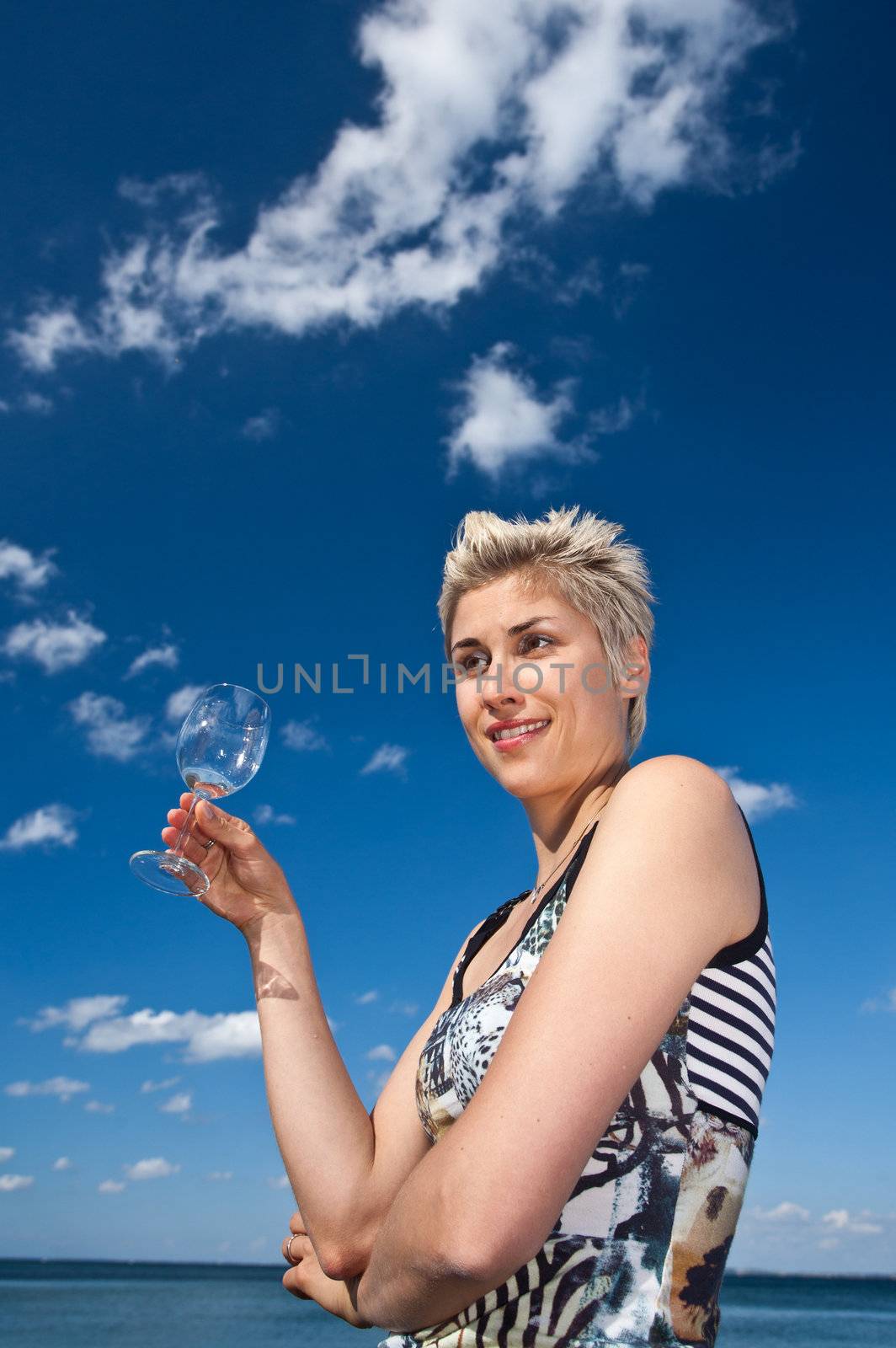 Cute blond girl playing with water in the summer in Denmark