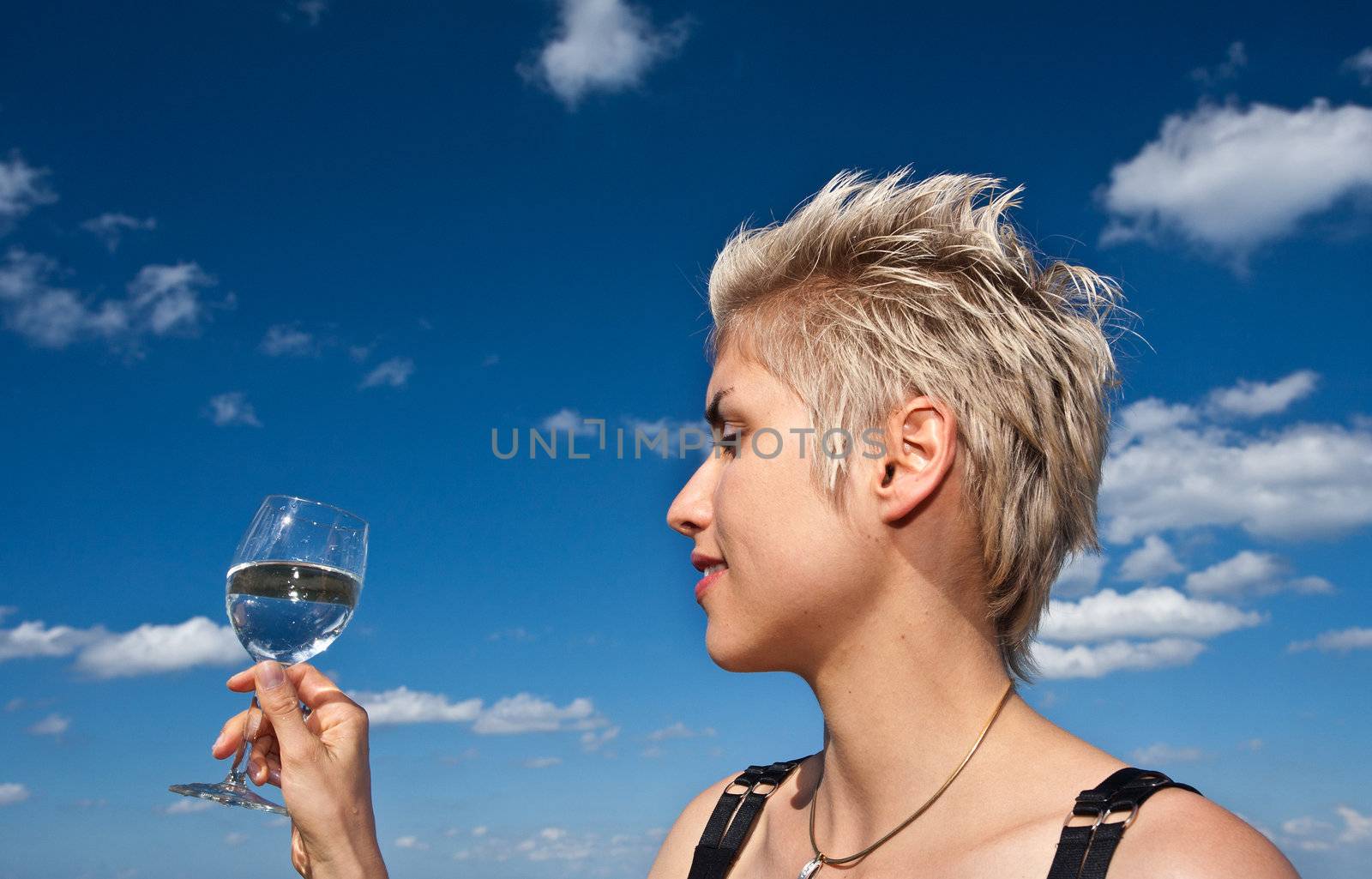 Cute blond girl playing with water in the summer in Denmark