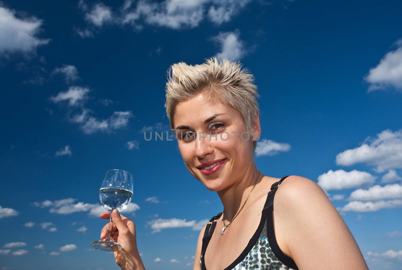 Cute blond girl playing with water in the summer in Denmark