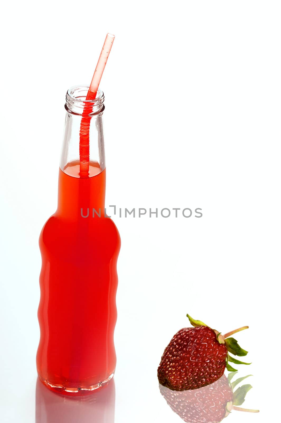 bottle of strawberry juice and strawberry on white