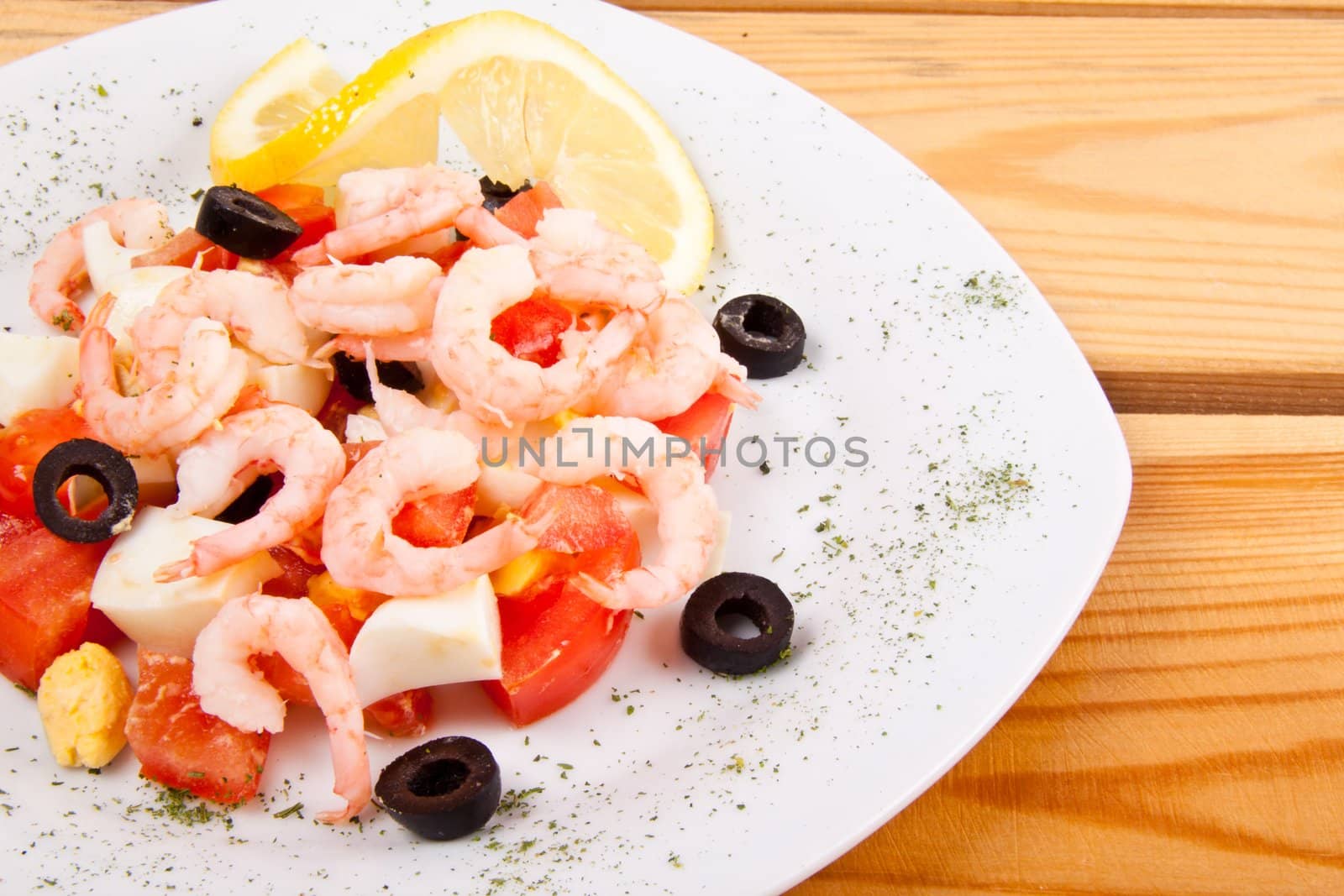Shrimp salad on white plate by ozaiachin