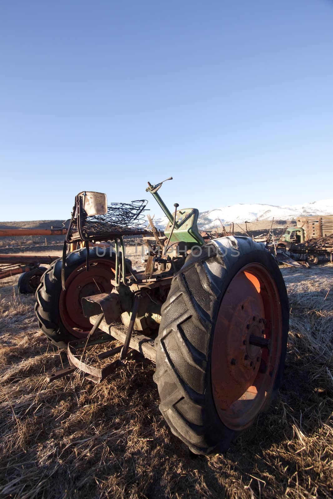 old rusty farm equipment in the middle of a field