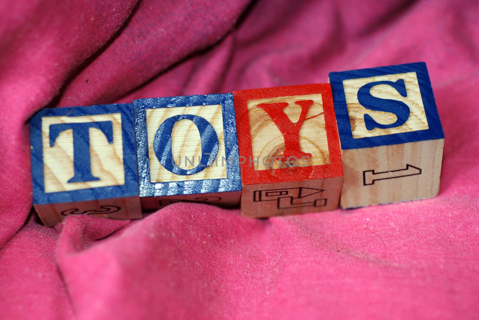 Educational wooden blocks spelling out the word Toys