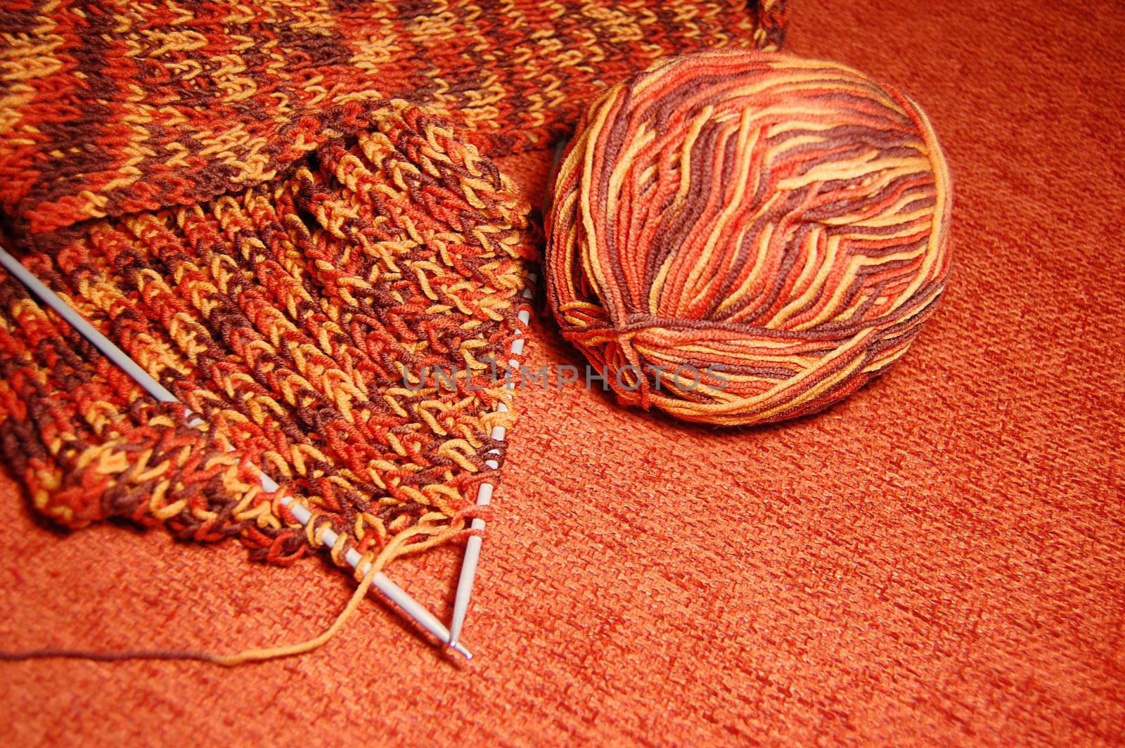 Knitting scarf from yarn with needles