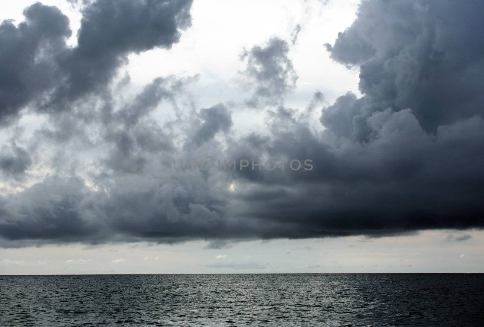Heavy clouds above ocean before a thunder-storm