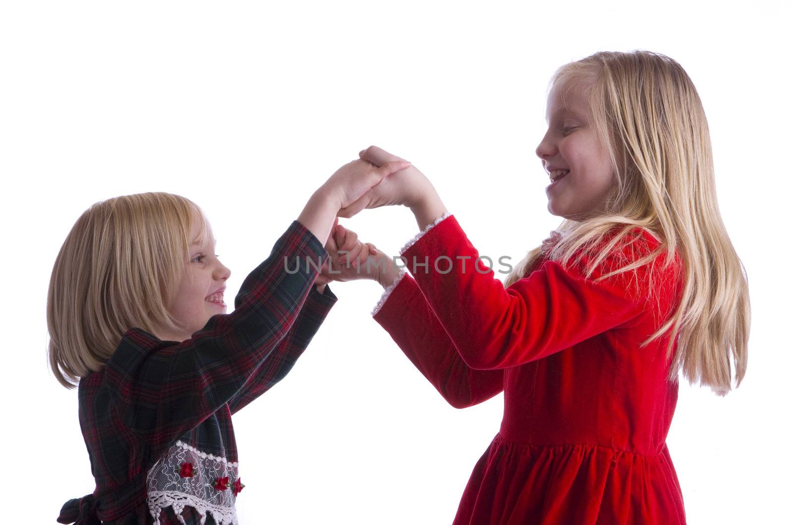 Sisters Dancing while wearing there Christmas Dresses