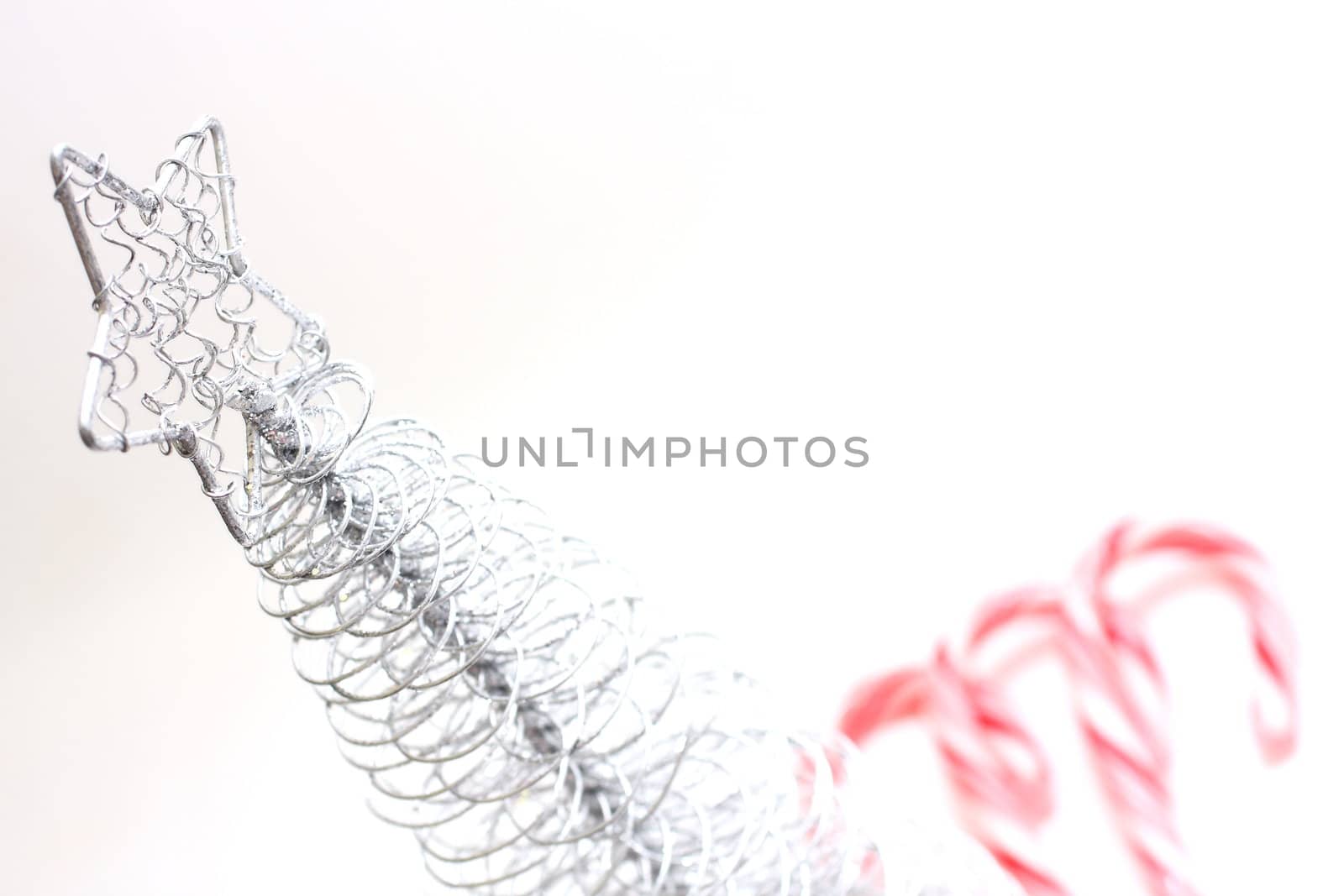 Christmas Tree and candy canes on white background.