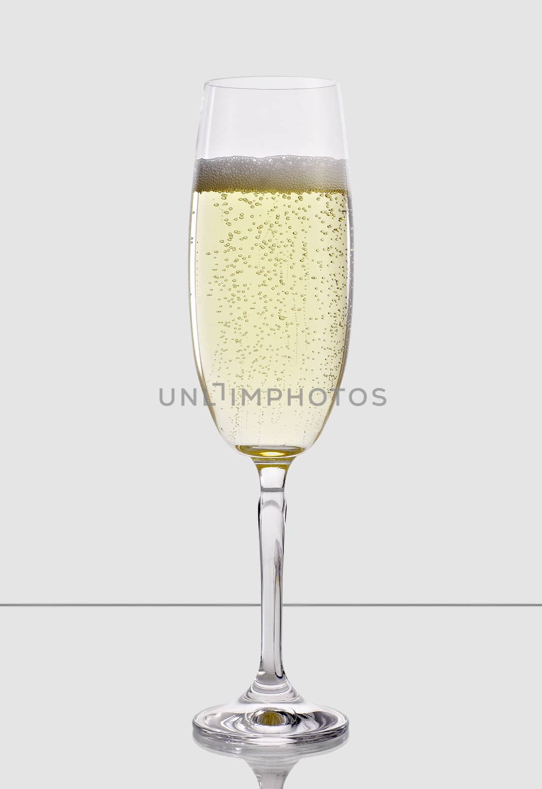 A glass of champagne, isolated on a white background.