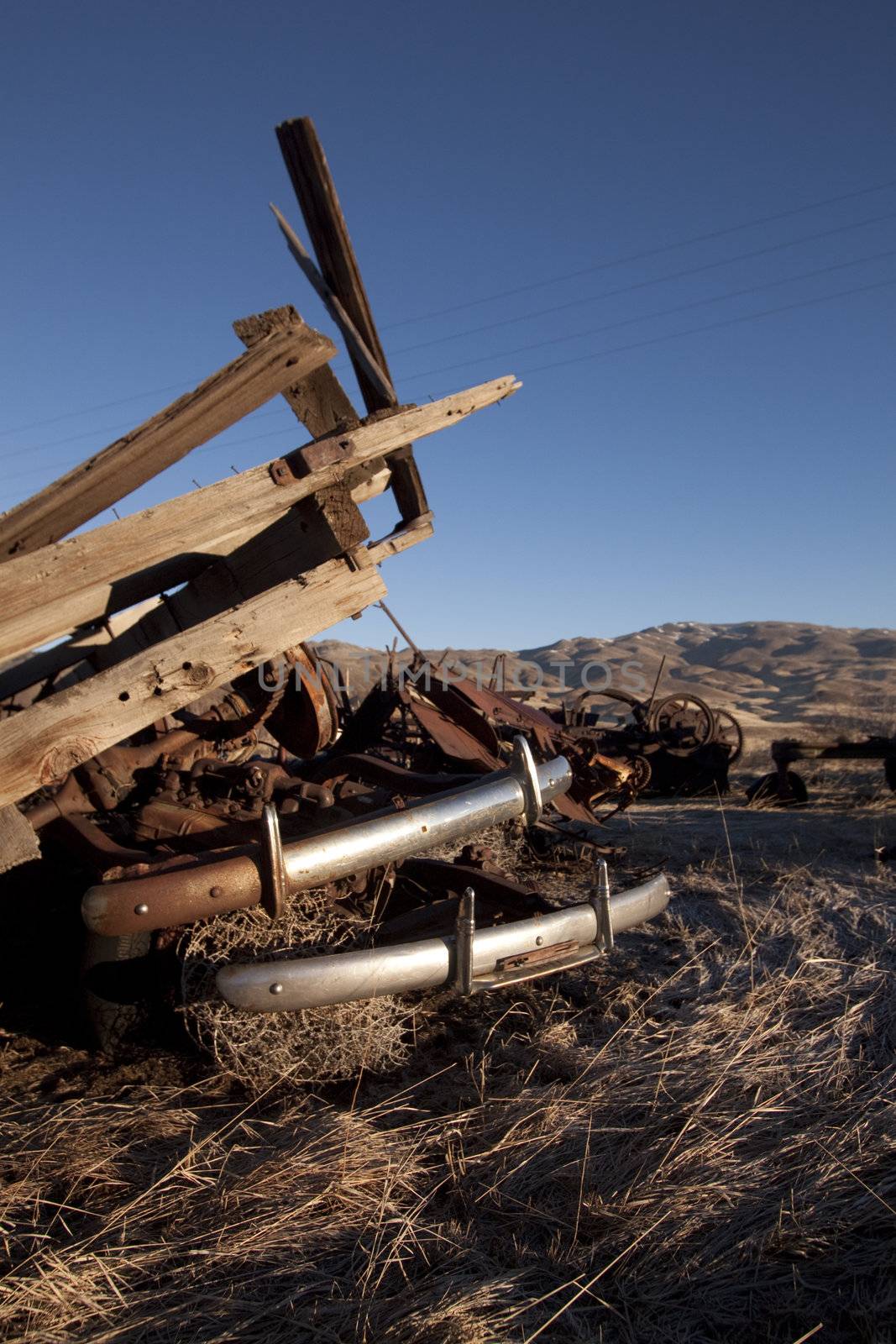 Old farm equipment in a field by jeremywhat