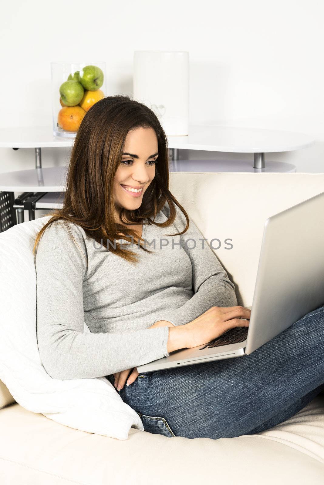 attractive relaxed woman is working at home on a sofa 