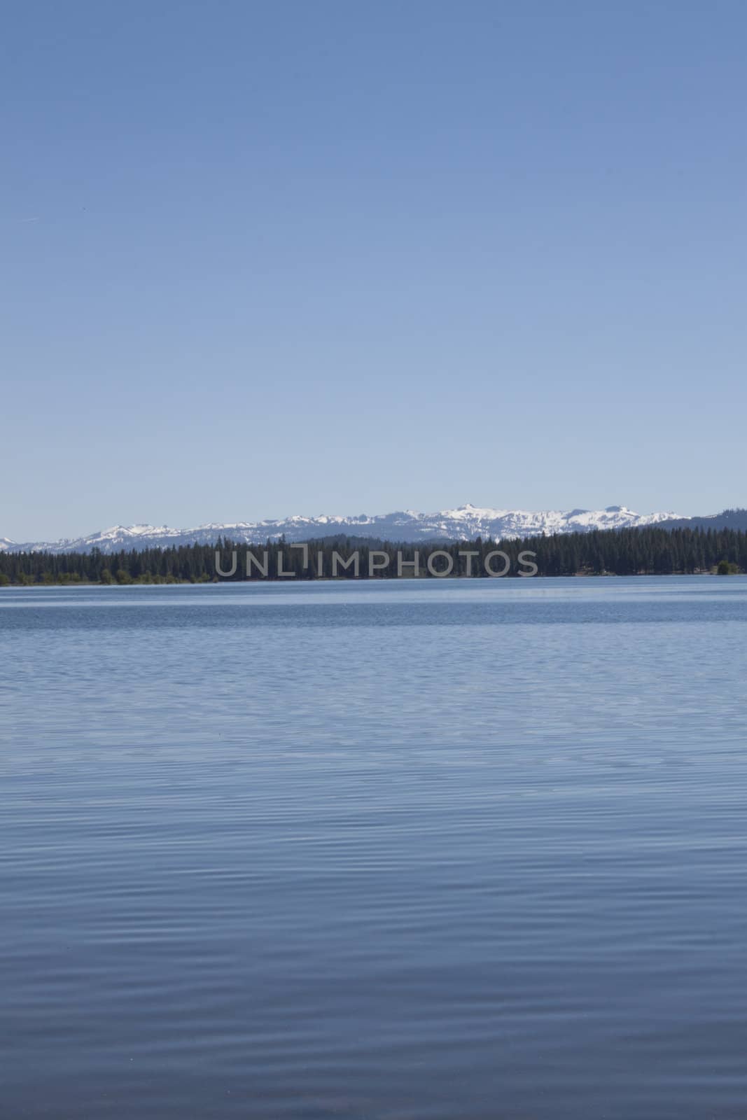 Empty lake with calm water surface in the mountains