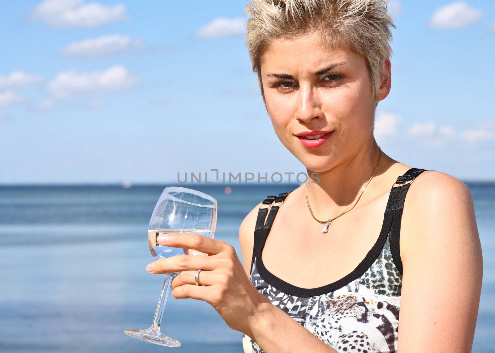 Cute blond girl playing with water in the summer in Denmark