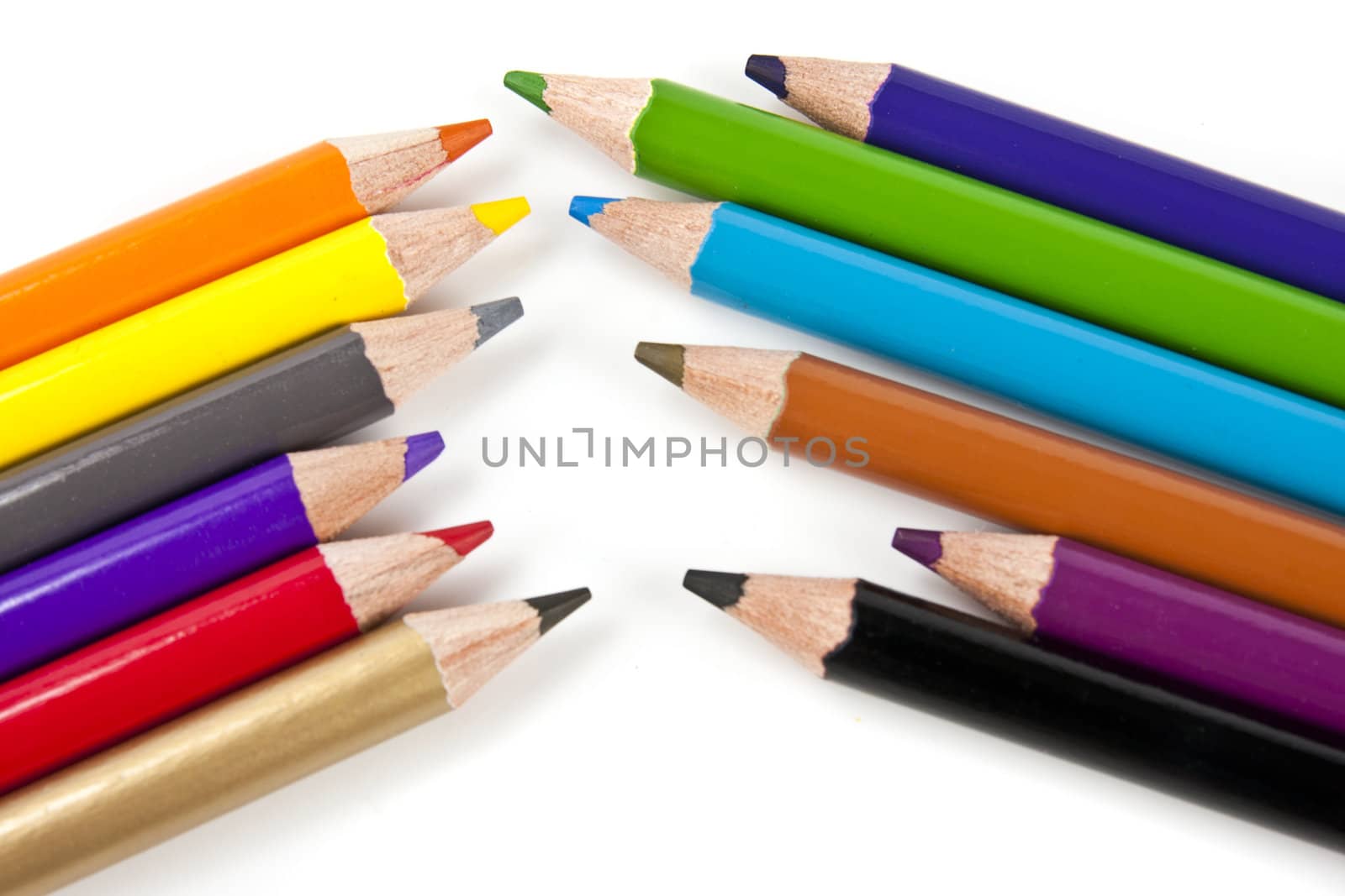 Color pencils in arrange in color wheel colors on white background