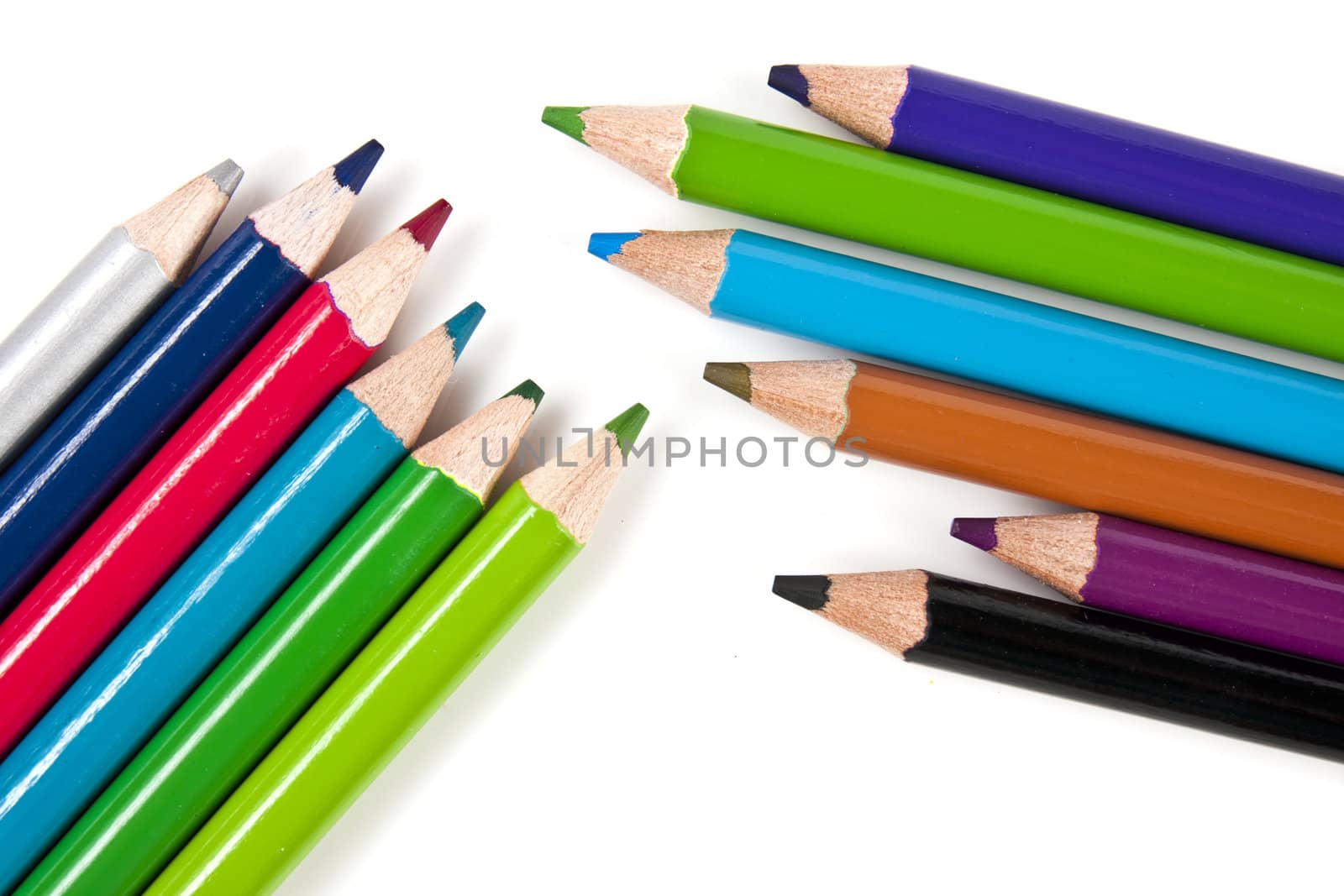 Color pencils in arrange in color wheel colors on white background