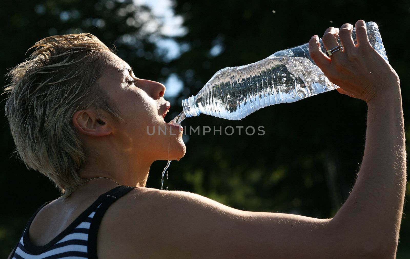 Cute blond girl playing with water in the summer in Denmark