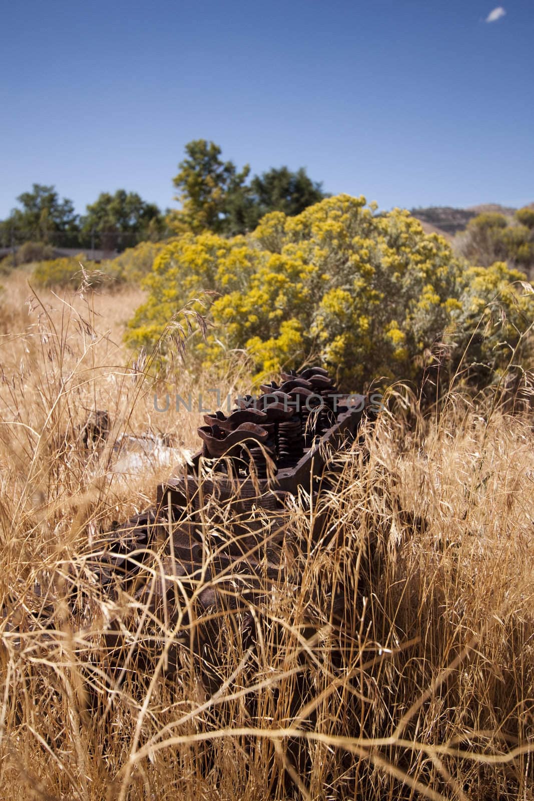 Old rusty engine block abandoned in the field.