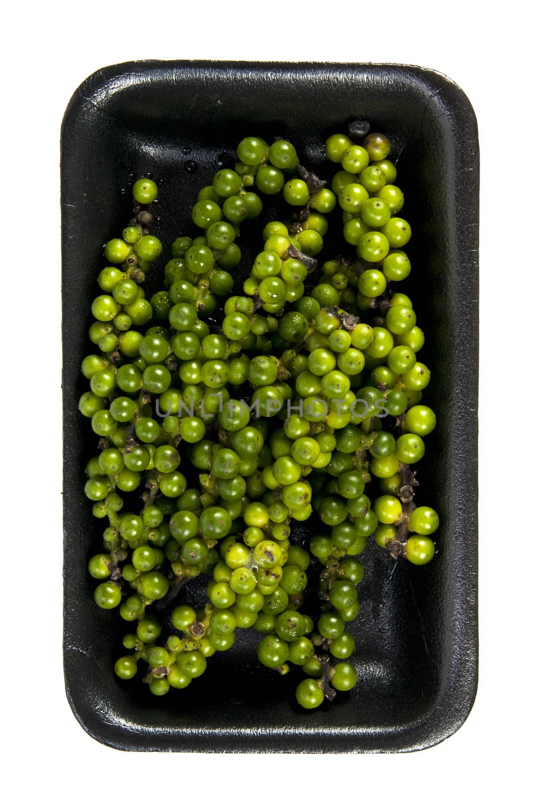 Green pepper cone with black plate on the white background