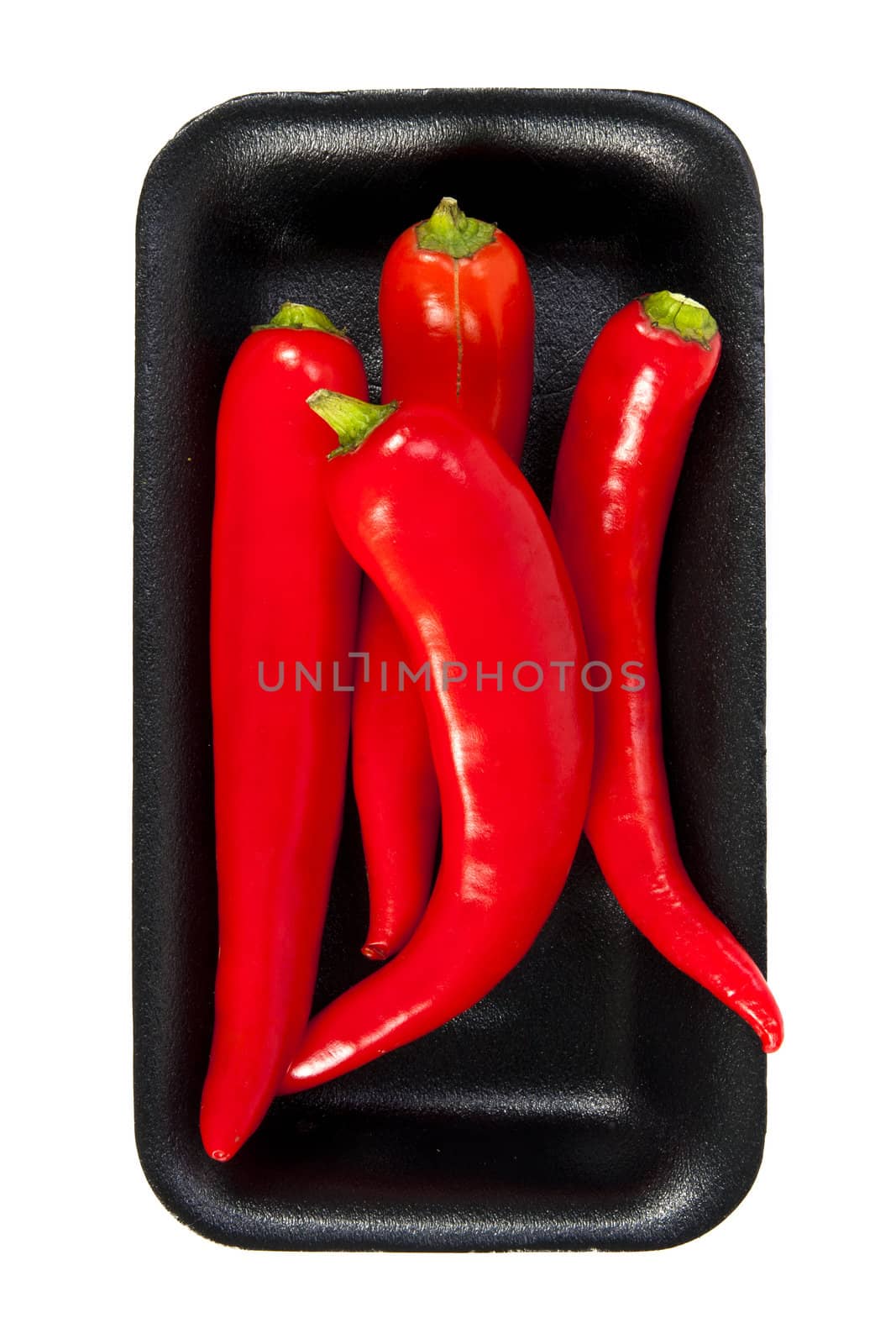 Fresh red hot pepper with black plate on a white background
